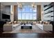 Bright living room with soaring ceilings, elegant furniture, and city views at 855 Peachtree Ne St # 2706, Atlanta, GA 30308