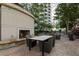 Outdoor dining area with a fireplace and grill in a landscaped setting at 855 Peachtree Ne St # 2706, Atlanta, GA 30308