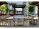 Outdoor grill area with a stainless steel grill, stone countertops, and seating at 855 Peachtree Ne St # 2706, Atlanta, GA 30308