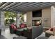 Outdoor living room with a fireplace, TV, and comfortable seating at 855 Peachtree Ne St # 2706, Atlanta, GA 30308
