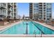 Rooftop pool with lounge chairs surrounded by landscaping and views of the city at 855 Peachtree Ne St # 2706, Atlanta, GA 30308