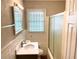 Bright bathroom features a tiled shower-tub and vanity with a white countertop and updated faucet at 955 Margaret Nw Pl, Atlanta, GA 30318