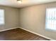 Bedroom with hardwood flooring, neutral walls, and two windows that provide plenty of natural light at 955 Margaret Nw Pl, Atlanta, GA 30318