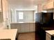 View of the kitchen from the living room, showcasing the breakfast bar and appliances at 955 Margaret Nw Pl, Atlanta, GA 30318