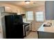 Well-lit kitchen featuring updated appliances and ample countertop space at 955 Margaret Nw Pl, Atlanta, GA 30318