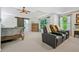 Spacious main bedroom with seating, a ceiling fan, neutral tones, and ample natural light at 155 Glenside Ln, Duluth, GA 30097