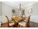Traditional dining room with decorative wainscoting, dark wood flooring and a classic chandelier at 155 Glenside Ln, Duluth, GA 30097