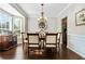 Traditional dining room with decorative wainscoting, dark wood flooring and a classic chandelier at 155 Glenside Ln, Duluth, GA 30097