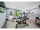 Well-lit home gym with weight equipment and large windows at 155 Glenside Ln, Duluth, GA 30097