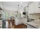 A modern kitchen with white cabinets, granite countertops, and stainless steel appliances and eat in kitchen at 155 Glenside Ln, Duluth, GA 30097