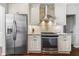 Stylish kitchen with stainless steel appliances, white cabinetry, and granite countertops at 155 Glenside Ln, Duluth, GA 30097
