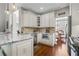 Bright and updated kitchen featuring white cabinets, granite countertops, and stainless steel appliances at 155 Glenside Ln, Duluth, GA 30097