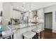 Modern kitchen with a breakfast bar, granite countertops, stainless steel appliances, and pendant lighting at 155 Glenside Ln, Duluth, GA 30097