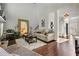 Cozy living room with a fireplace, plush seating, and hardwood floors at 155 Glenside Ln, Duluth, GA 30097