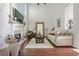 Bright living room featuring high ceilings, fireplace, hardwood floors, and an oversized decorative mirror at 155 Glenside Ln, Duluth, GA 30097