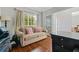 Home office featuring hardwood floors, a neutral sofa with pink pillows, and a large bright window at 155 Glenside Ln, Duluth, GA 30097