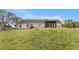 Expansive backyard featuring well-maintained lawn, covered patio, and mature trees, ideal for outdoor enjoyment at 173 Michael Ln, Mcdonough, GA 30252