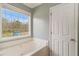 Primary bathroom with large window, soaking tub, and lots of natural light at 173 Michael Ln, Mcdonough, GA 30252