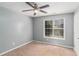 Bedroom featuring plush carpeting, ceiling fan, neutral walls, and a large window at 173 Michael Ln, Mcdonough, GA 30252