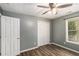Well-lit bedroom featuring modern plank flooring, closet, and neutral walls at 173 Michael Ln, Mcdonough, GA 30252