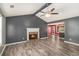 Bright living room with hardwood floors, a fireplace, ceiling fan, gray walls, and an open concept layout at 173 Michael Ln, Mcdonough, GA 30252