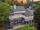 Aerial view of a large, well-maintained home with an outdoor deck and lush landscaping at 21 Edgewater Se Dr, Cartersville, GA 30121