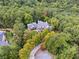 Aerial view of estate surrounded by mature trees in a tranquil setting at 21 Edgewater Se Dr, Cartersville, GA 30121