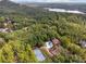 Stunning aerial view of a private estate featuring a pool, tennis court, and lush, mature landscaping near a lake at 21 Edgewater Se Dr, Cartersville, GA 30121