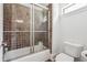 Bathroom with a tiled shower and tub combination, alongside a white toilet at 21 Edgewater Se Dr, Cartersville, GA 30121