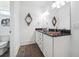 Bathroom with double vanity, dark countertops, and tile flooring, plus a toilet to the side at 21 Edgewater Se Dr, Cartersville, GA 30121