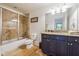 Bathroom featuring granite countertops, tile shower, vanity lighting, and tiled floors at 21 Edgewater Se Dr, Cartersville, GA 30121