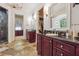 Bathroom with dual vanities, stone floors, and a glass shower enclosure at 21 Edgewater Se Dr, Cartersville, GA 30121