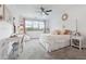 Bright bedroom featuring neutral decor, a ceiling fan, and a well-lit desk area at 21 Edgewater Se Dr, Cartersville, GA 30121