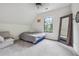 Minimalist bedroom featuring an arched window, neutral carpet, and a framed mirror in the corner at 21 Edgewater Se Dr, Cartersville, GA 30121