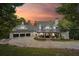 Beautiful exterior of this spacious home with a three car garage and inviting front porch at sunset at 21 Edgewater Se Dr, Cartersville, GA 30121