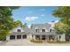 Beautiful exterior of this spacious home with a three car garage and inviting front porch with beautiful stone pillars at 21 Edgewater Se Dr, Cartersville, GA 30121
