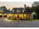 Beautiful exterior of this spacious home with a three car garage and inviting front porch at dusk at 21 Edgewater Se Dr, Cartersville, GA 30121