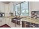 Kitchen with granite countertops, stainless steel sink, and view of sunroom at 21 Edgewater Se Dr, Cartersville, GA 30121