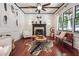 Cozy living room with fireplace, wood floors, and large windows providing plenty of natural light at 21 Edgewater Se Dr, Cartersville, GA 30121