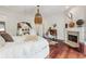 Bright main bedroom with hardwood floors, fireplace, and stylish décor at 21 Edgewater Se Dr, Cartersville, GA 30121