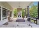 Inviting covered patio boasts a brick fireplace, ceiling fan and comfortable seating at 21 Edgewater Se Dr, Cartersville, GA 30121