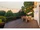 Outdoor patio with a dining table, string lights, and natural wooded view at 21 Edgewater Se Dr, Cartersville, GA 30121