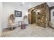 Unique sitting area with stone accent wall, archway and comfortable seating with decorative stool at 21 Edgewater Se Dr, Cartersville, GA 30121