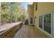 Spacious wooden back deck offers serene views and access to the home's interior at 6221 Woodlore Nw Dr, Acworth, GA 30101