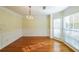 Traditional dining room with wainscoting, chandelier, and natural light at 6221 Woodlore Nw Dr, Acworth, GA 30101