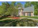 Traditional brick home with black shutters, lush lawn, and fresh landscaping at 6221 Woodlore Nw Dr, Acworth, GA 30101