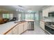 Well-lit kitchen with stainless steel appliances, eat-in nook, and backyard access at 6221 Woodlore Nw Dr, Acworth, GA 30101