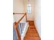 Wooden staircase leading to the upper level with a light-filled window at 6221 Woodlore Nw Dr, Acworth, GA 30101