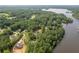 Aerial view showing a home site on waterfront property with mature trees and lake access at 123 Wildwood Dr, Temple, GA 30179