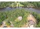 Aerial view of a waterfront property nestled among mature trees, offering privacy and scenic beauty at 123 Wildwood Dr, Temple, GA 30179